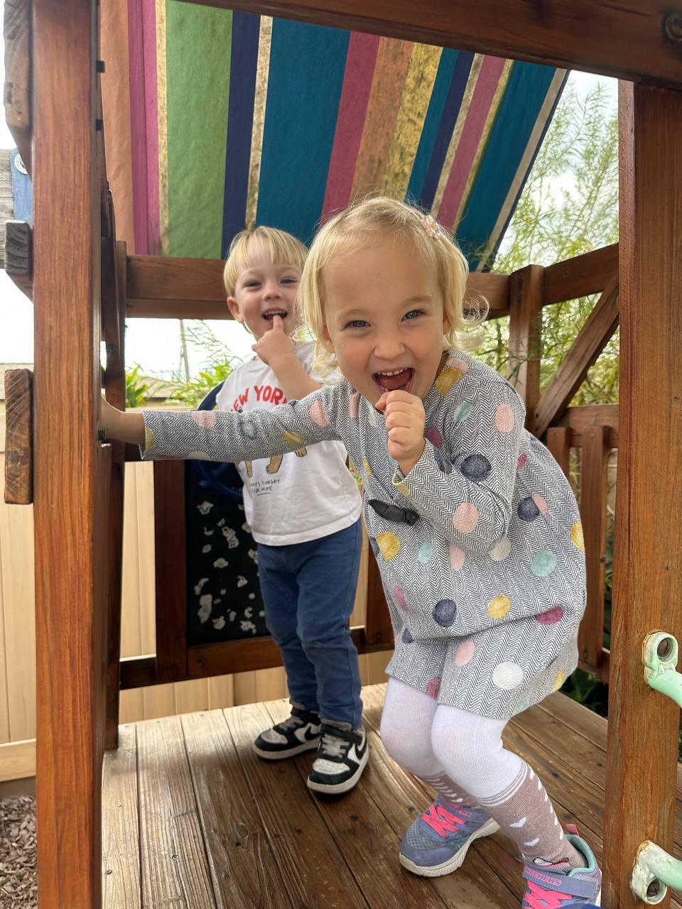 Laughing on the backyard playhouse